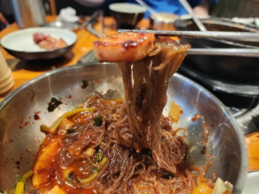 Bibim-naengmyeon wrapped around a piece of beef short rib
