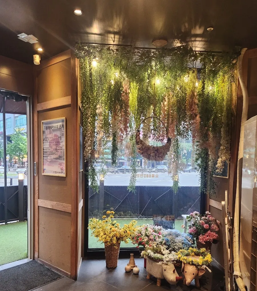 Restaurant entrance decorated with plants