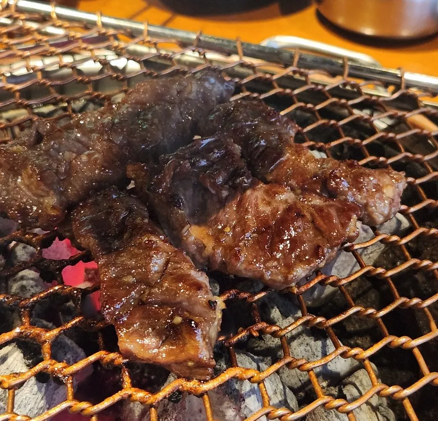 Garlic and meat cooking on the grill plate