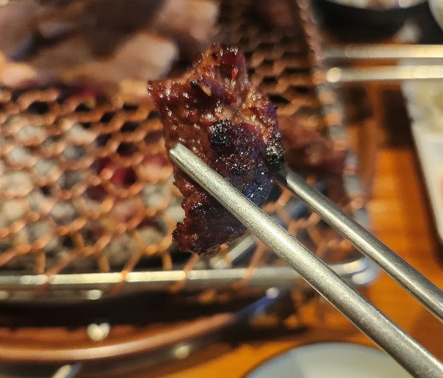 Finished pork belly with a piece of garlic
