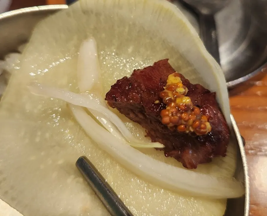 A wrap of meat with side dishes