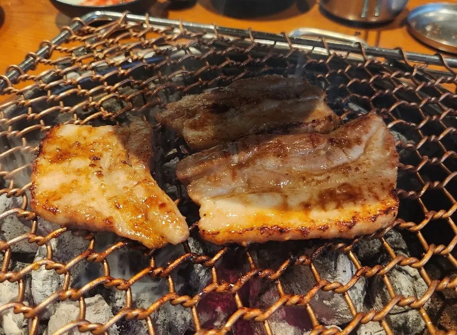Seasoned pork ribs being grilled