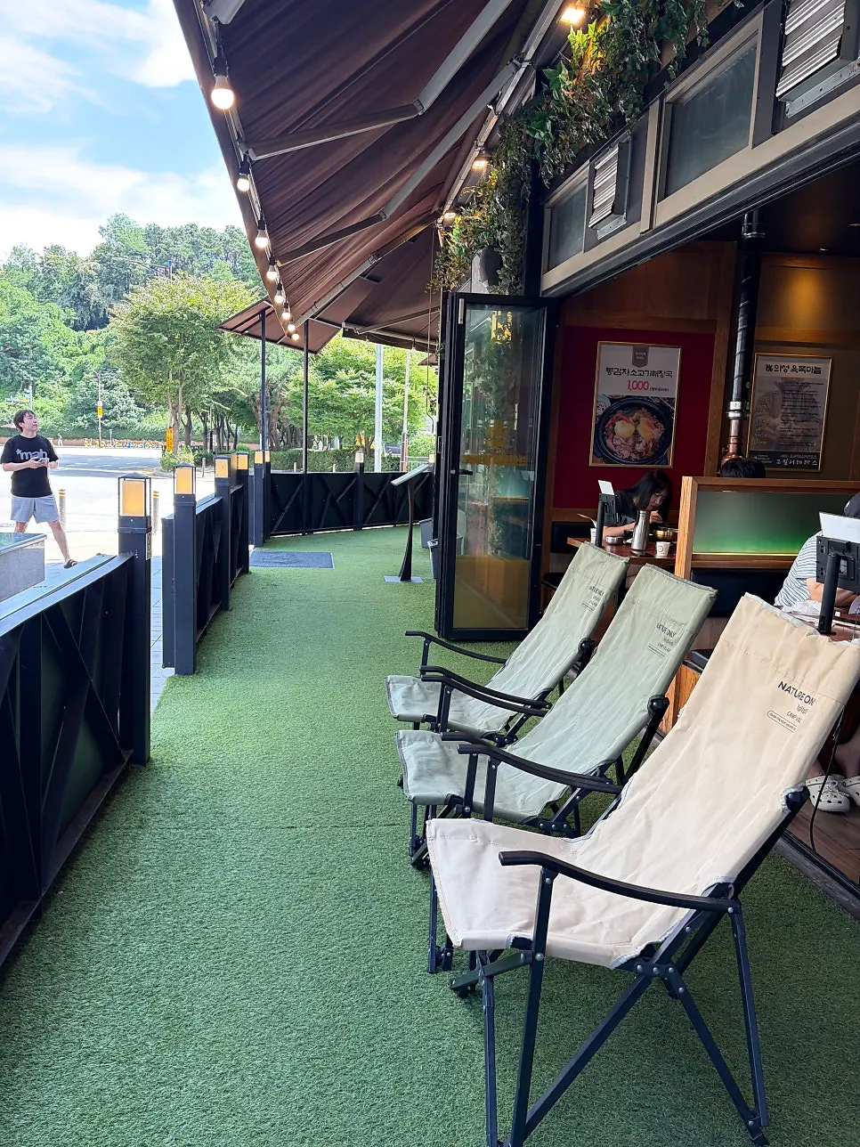 Terrace-style seating in front of the floor-to-ceiling windows