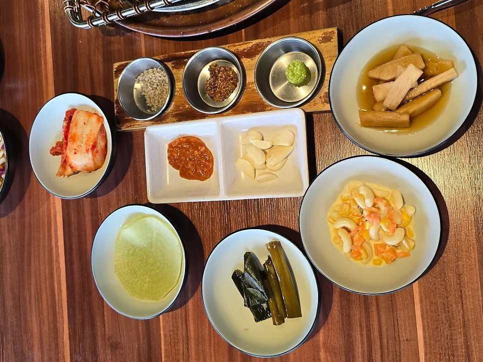 A spread of basic side dishes including kimchi and mountain leek pickle