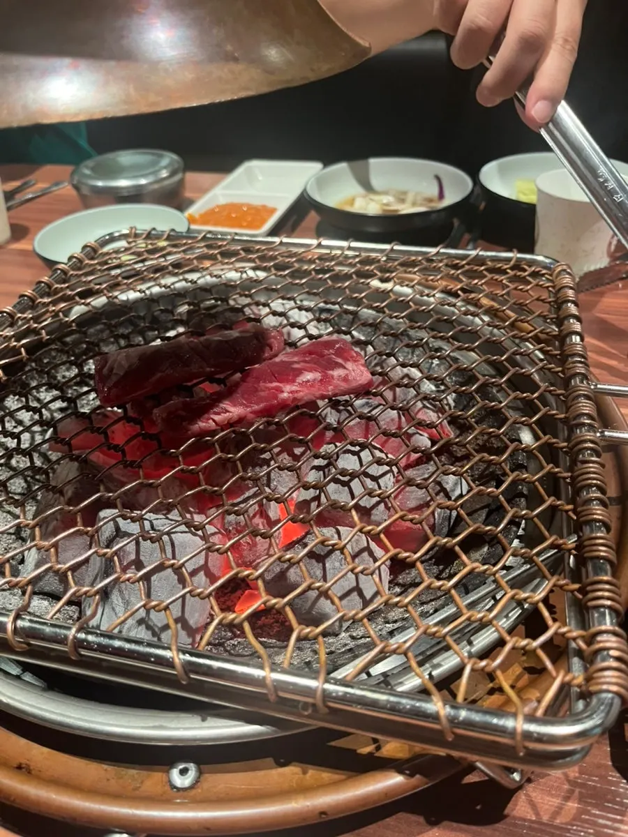 A full spread of grilled meat and side dishes