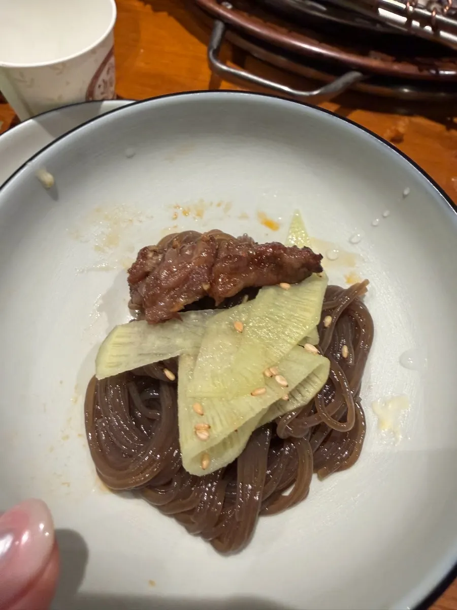 Lifting up a bite of cold noodles