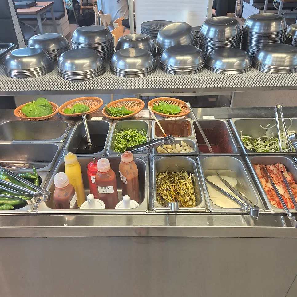 A spread of basic side dishes including green onion kimchi