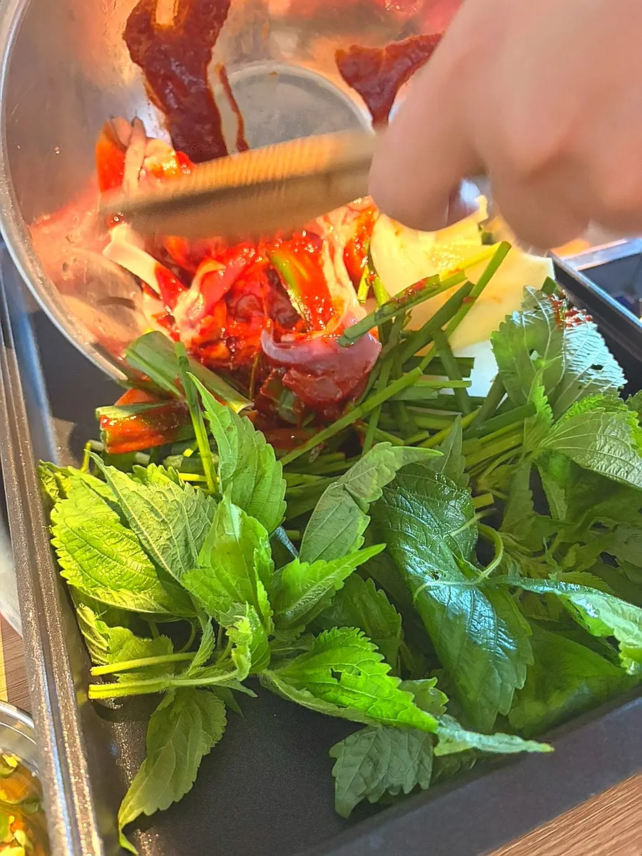 Side dishes with wrap greens and pickled Cheongyang peppers