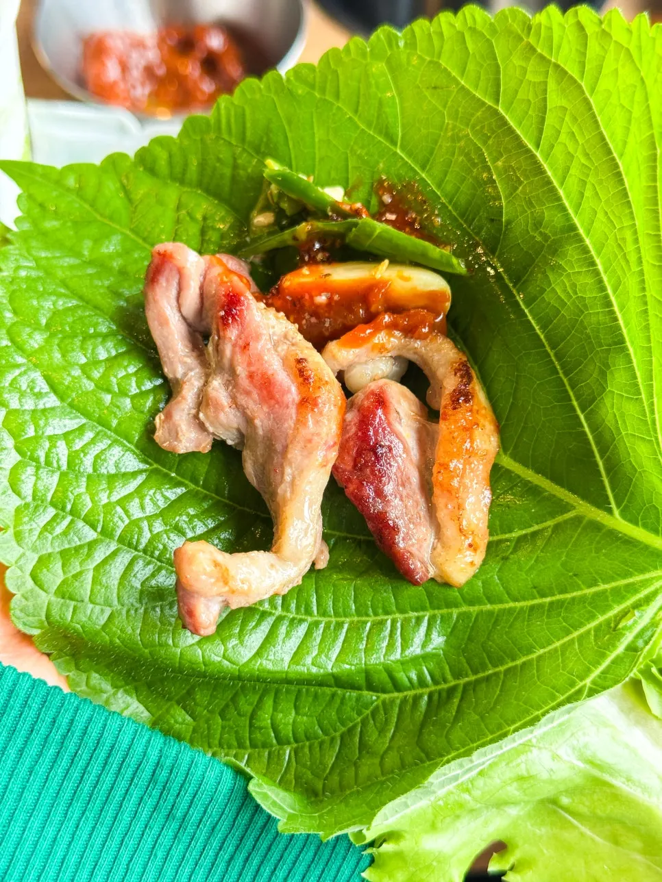 A piece of raw duck with garlic and ssamjang