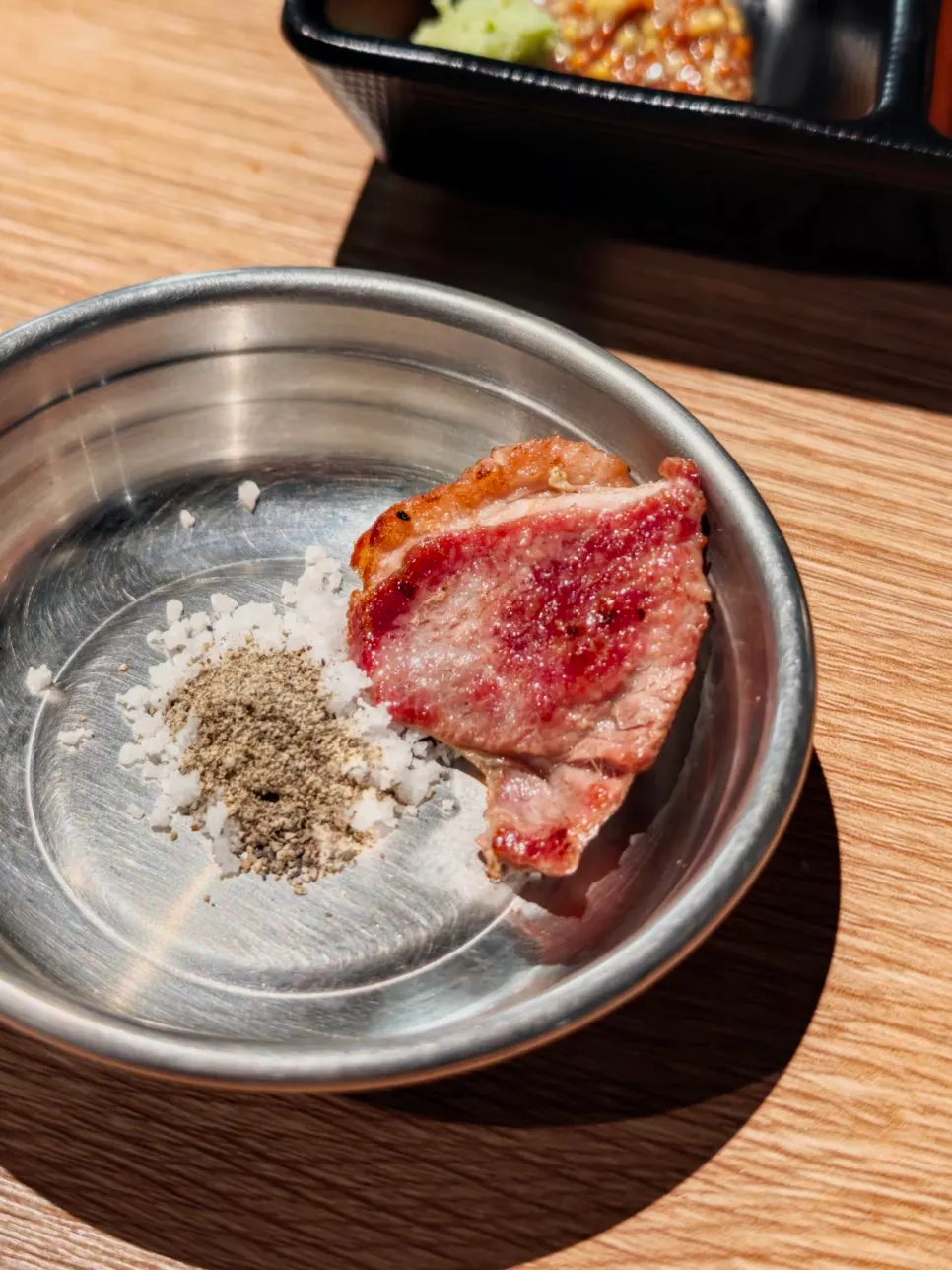 First bite of raw duck dipped in salt