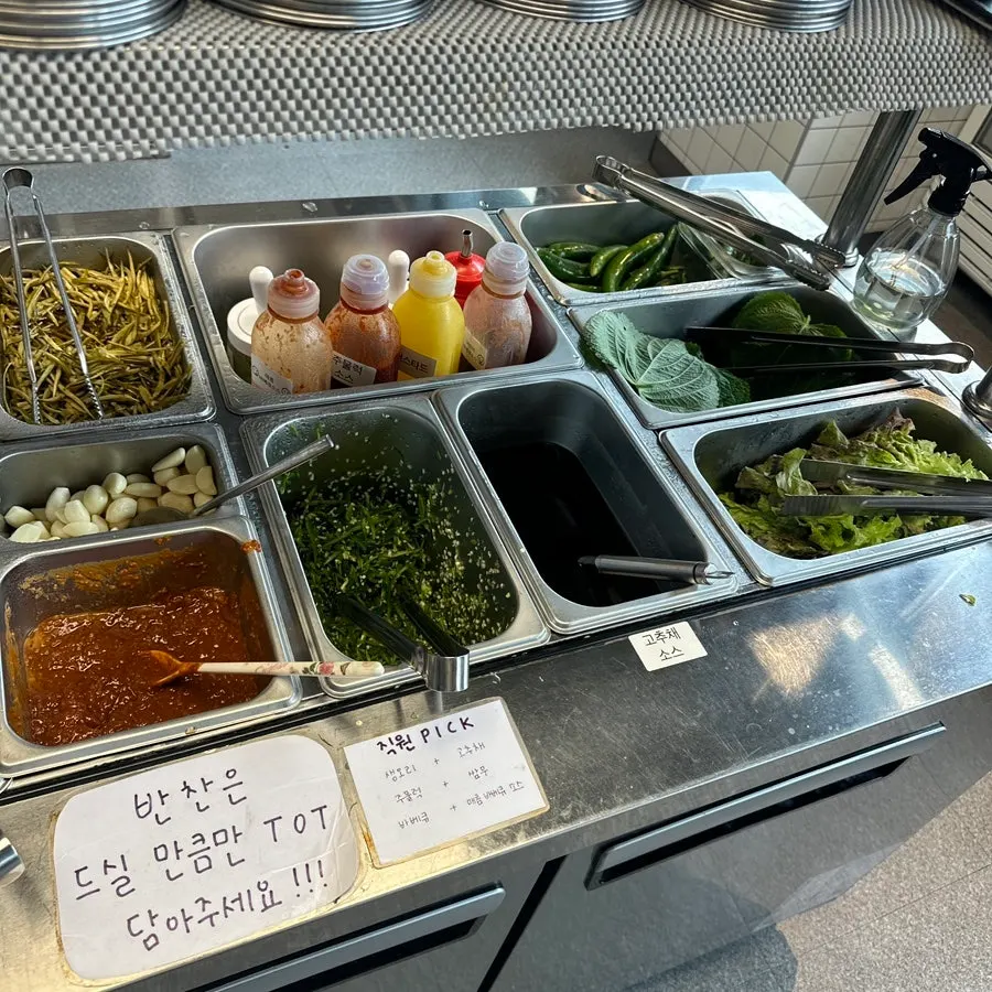 Various sauces set out at the self-serve bar