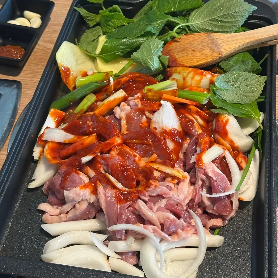 Table set with half a raw duck and one marinated duck