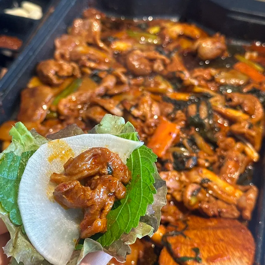 Duck meat wrapped in lettuce leaves