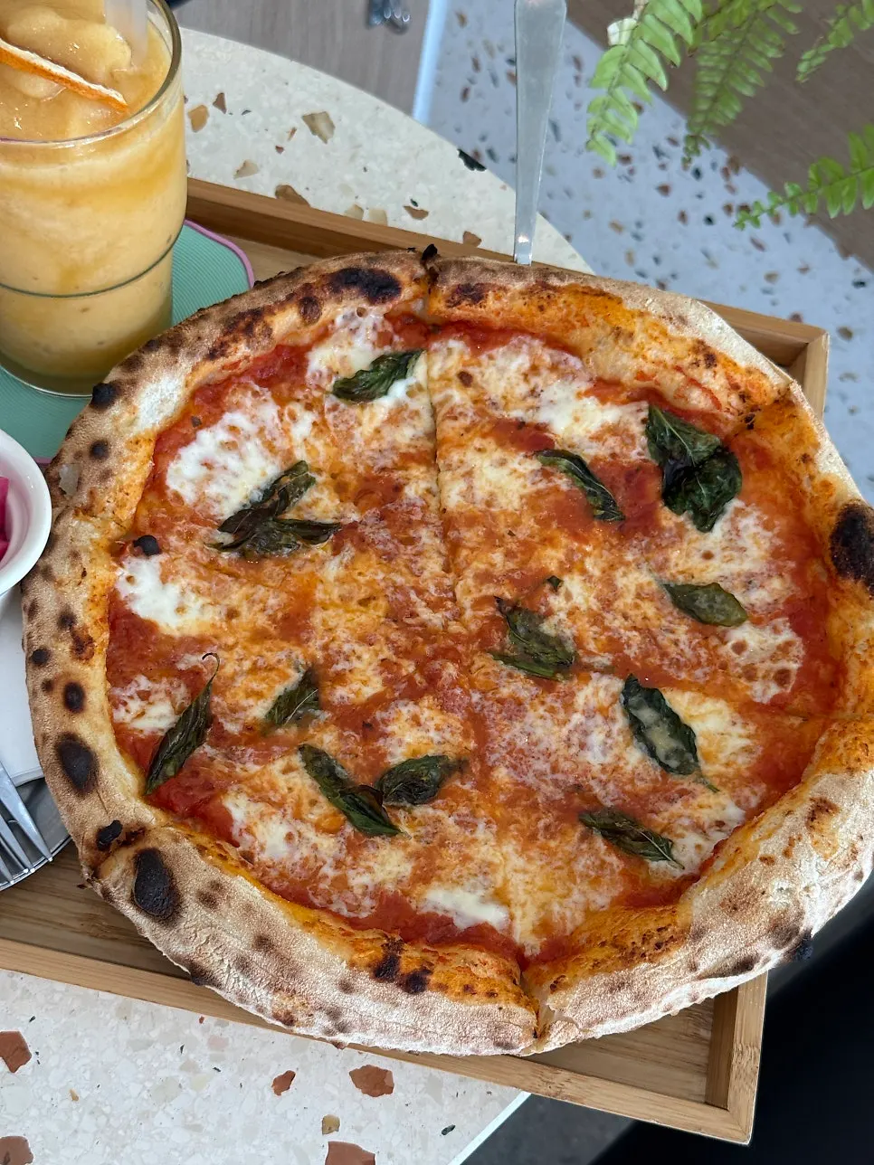 Margherita pizza and drinks served at the table
