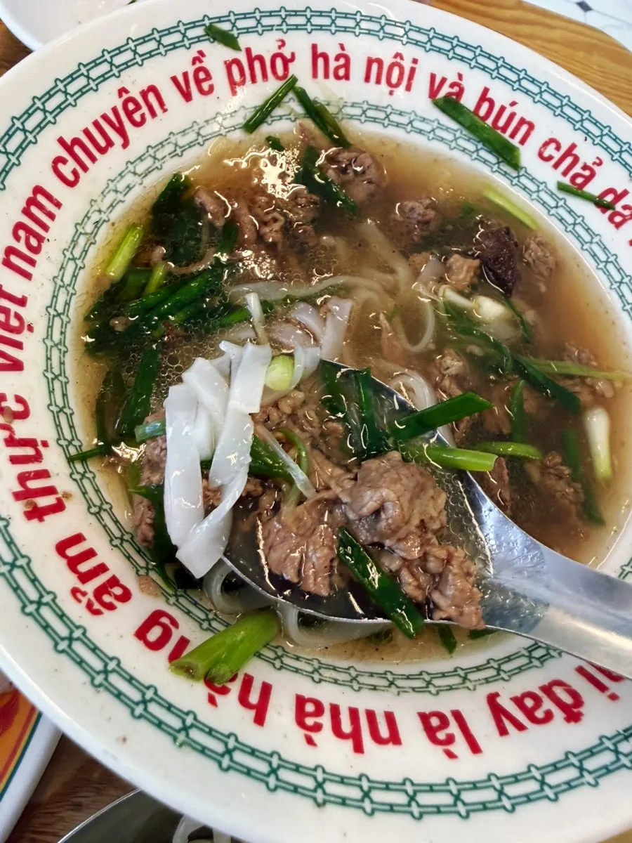 A spoonful of tender meat and noodles from the pho