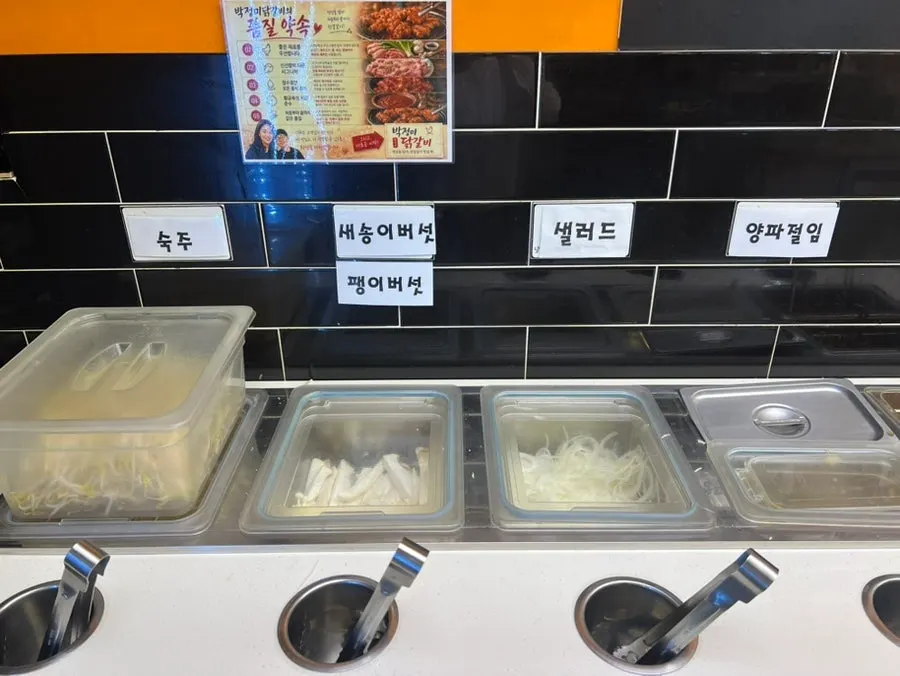 Trays of dakgalbi sorted by seasoning at the self-serve bar