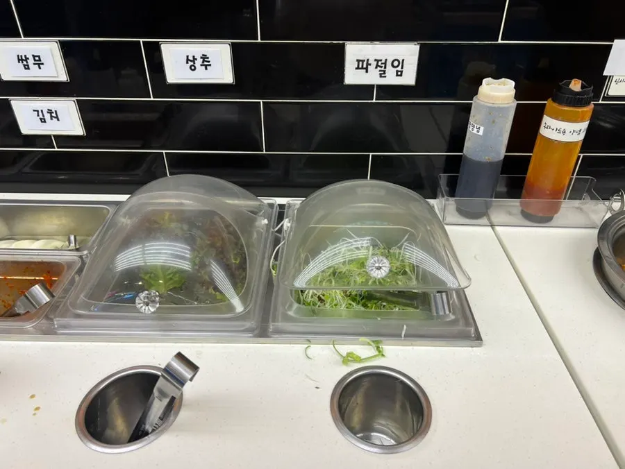 Vegetable self-serve bar with bean sprouts and onions