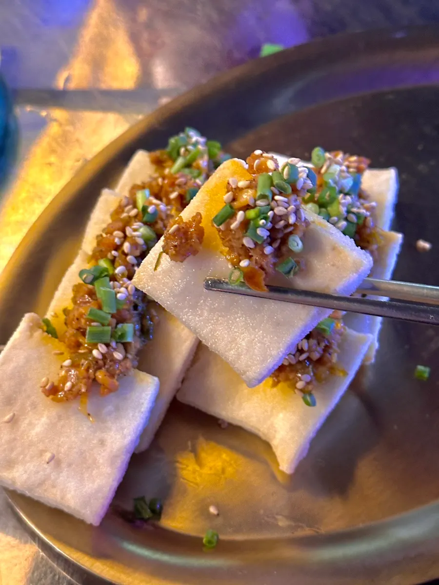 Close-up of a bite of tofu with meat