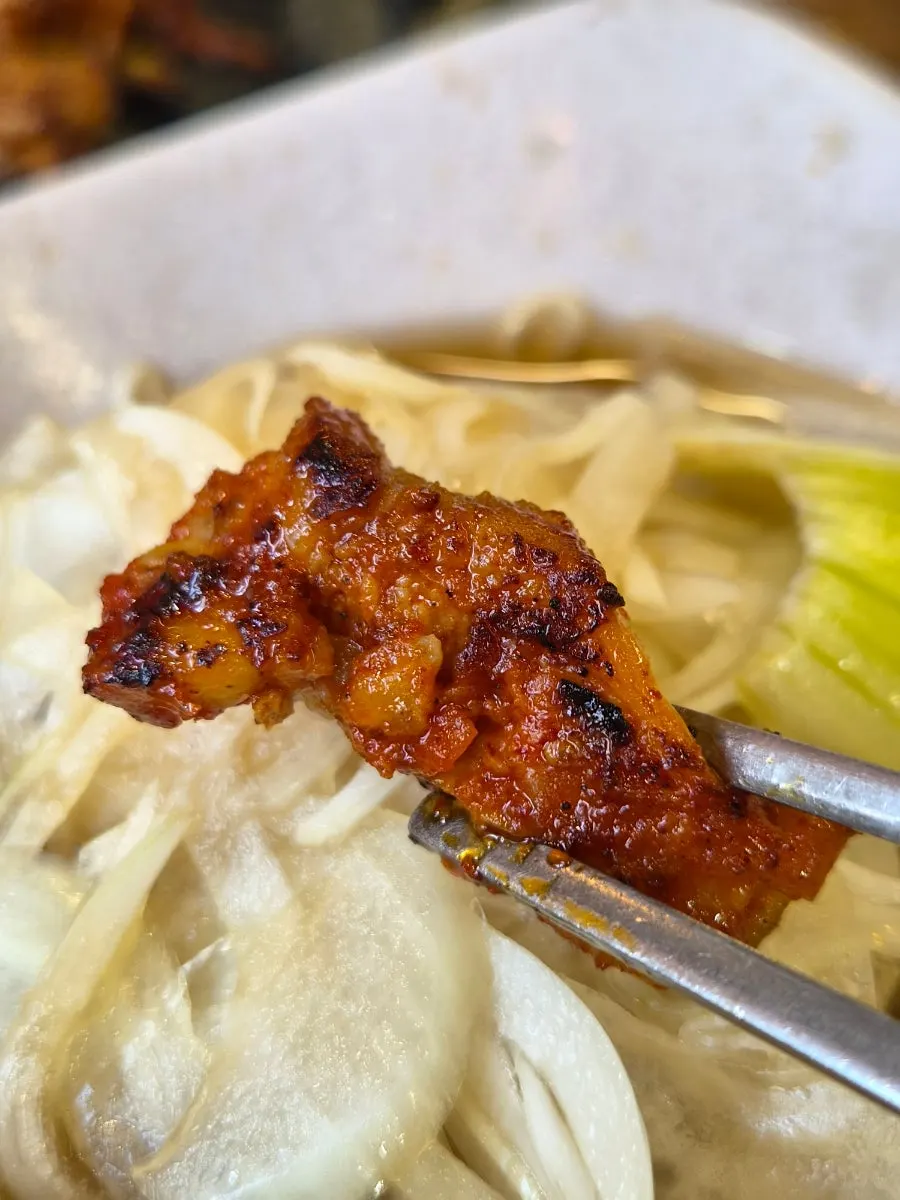 Close-up of dakgalbi with charcoal aroma rising