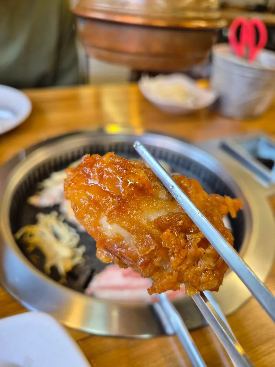 A piece of chicken eaten alongside the grilled meat