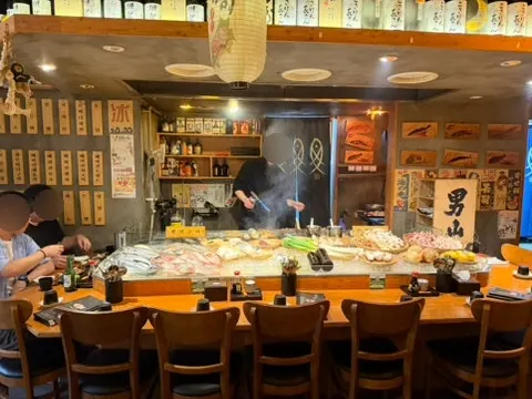 Open kitchen in front of the bar-counter seats