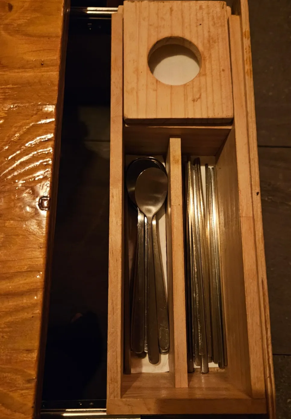 Table drawer with organized utensils and napkins