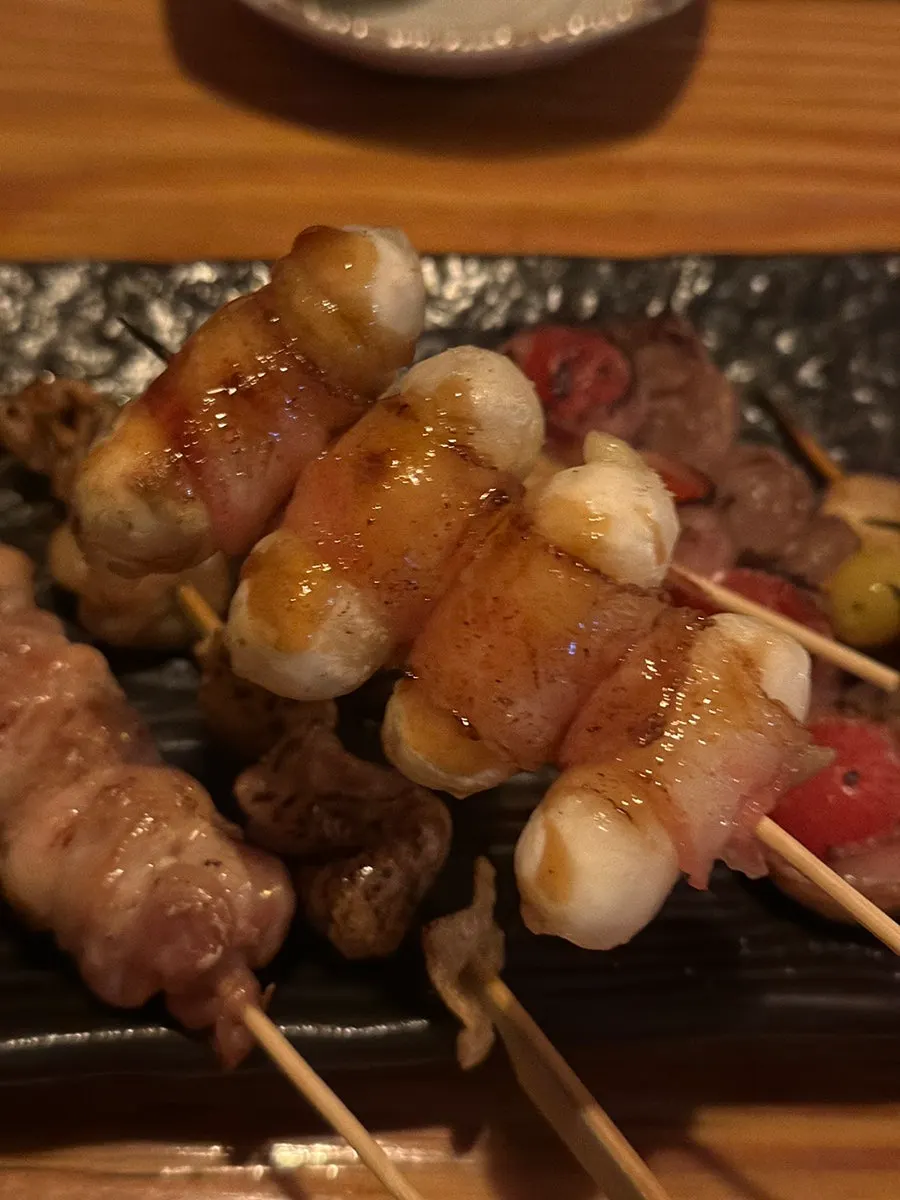 A chicken skewer with a bite taken out