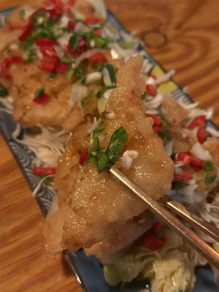 A piece of yurinki coated in sauce