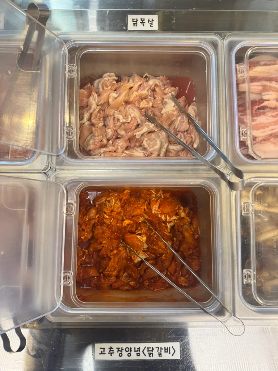 All-you-can-eat meat station with chicken neck on display