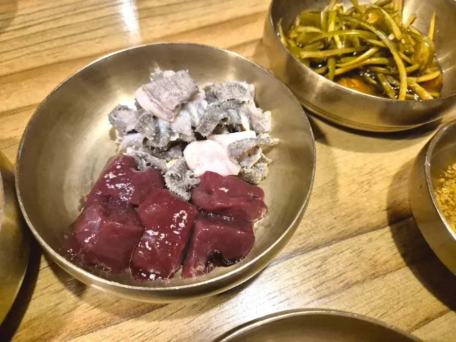 A plate of fresh raw liver served alongside the meal