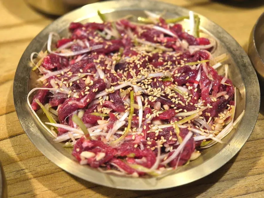 Beef yukhoe tossed with scallion and garlic