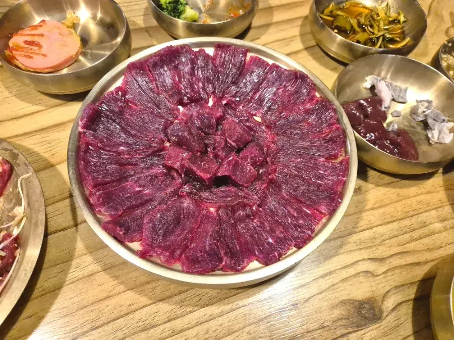 Cow raw beef plated with layered, distinct grain