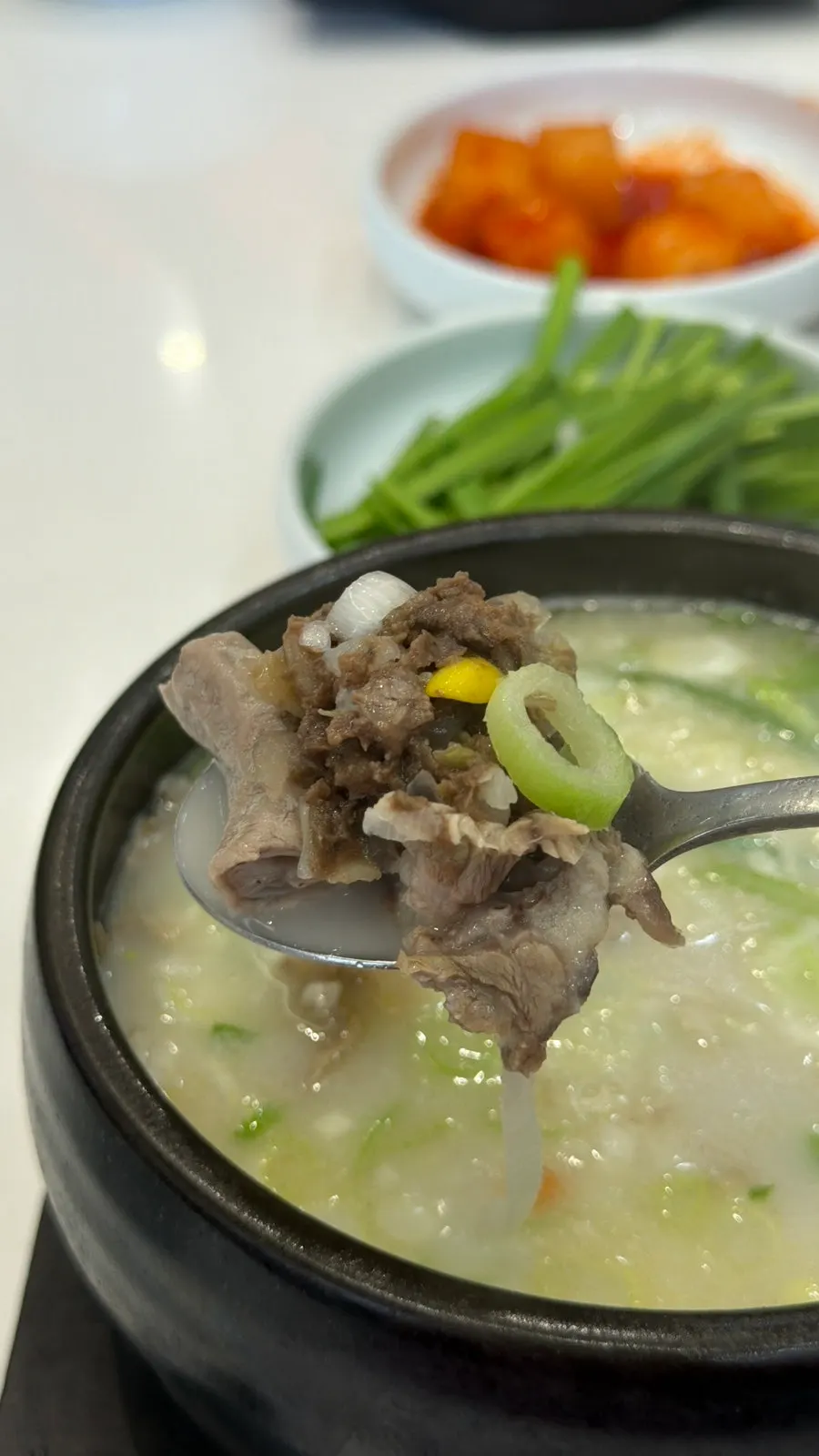 A spoonful of ingredients scooped from the mixed sundae gukbap
