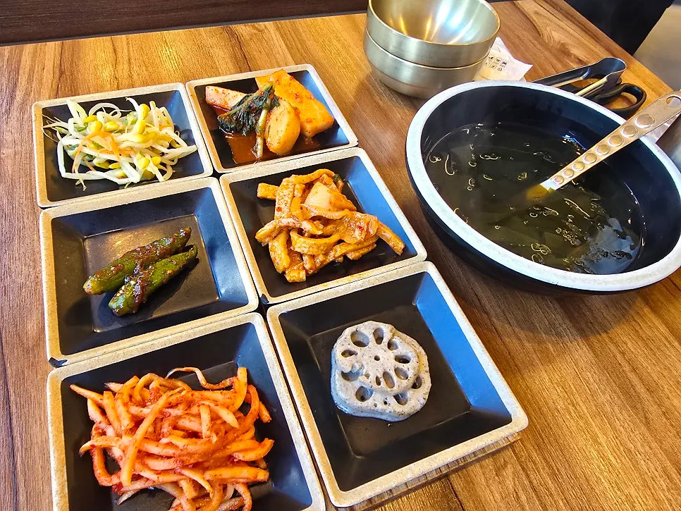 Assorted wood-fired grilled fish table setting for two at Guigo