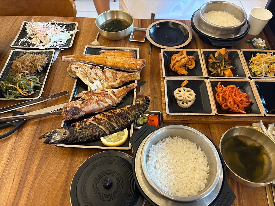 Table spread with four kinds of assorted grilled fish