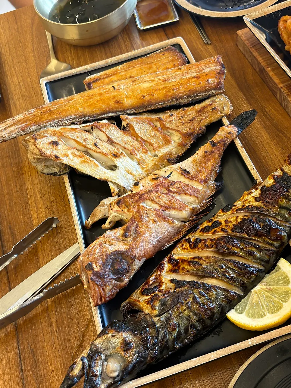 A piece of grilled fish placed on top of hot pot rice