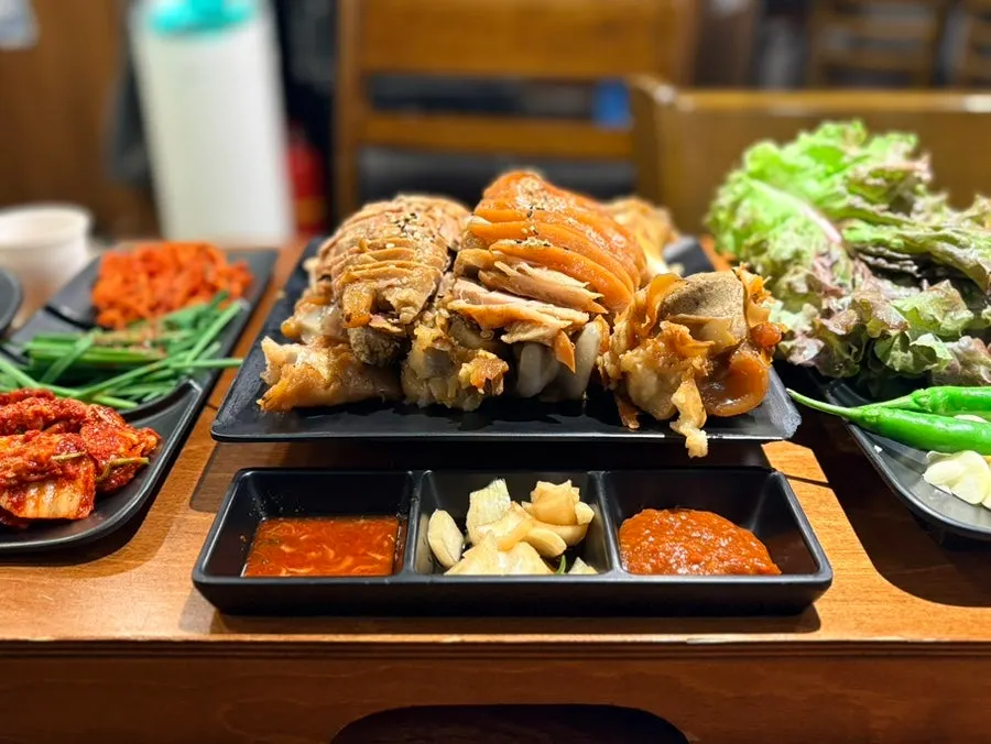 Table spread with radish salad, kimchi and other basic side dishes