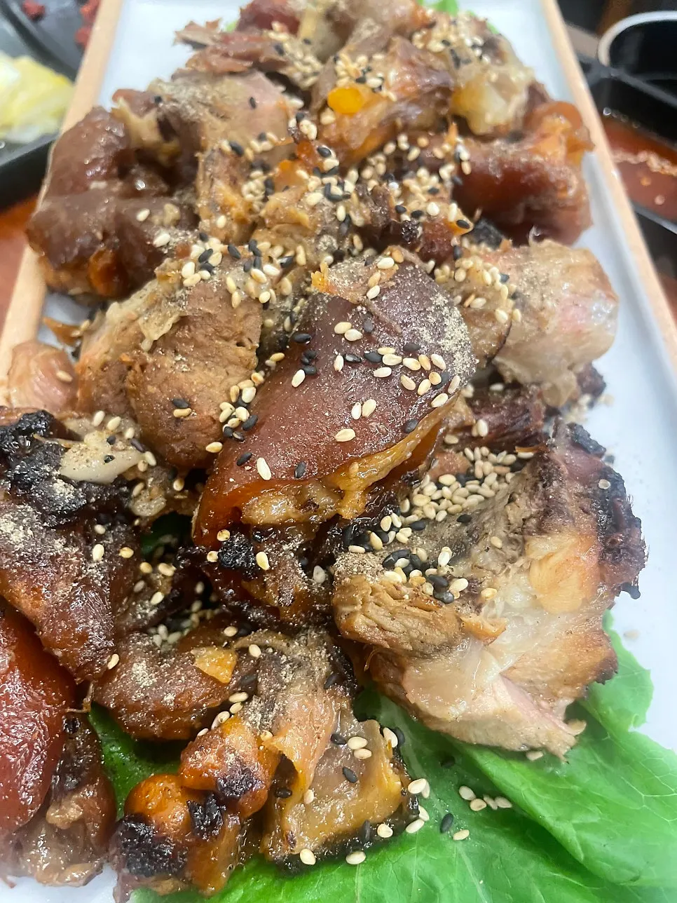 Table spread full of smoky charcoal-grilled jokbal