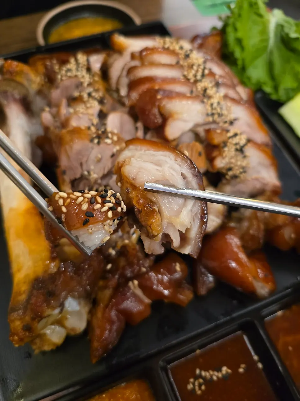 Glossy jokbal meat topped with black and white sesame seeds