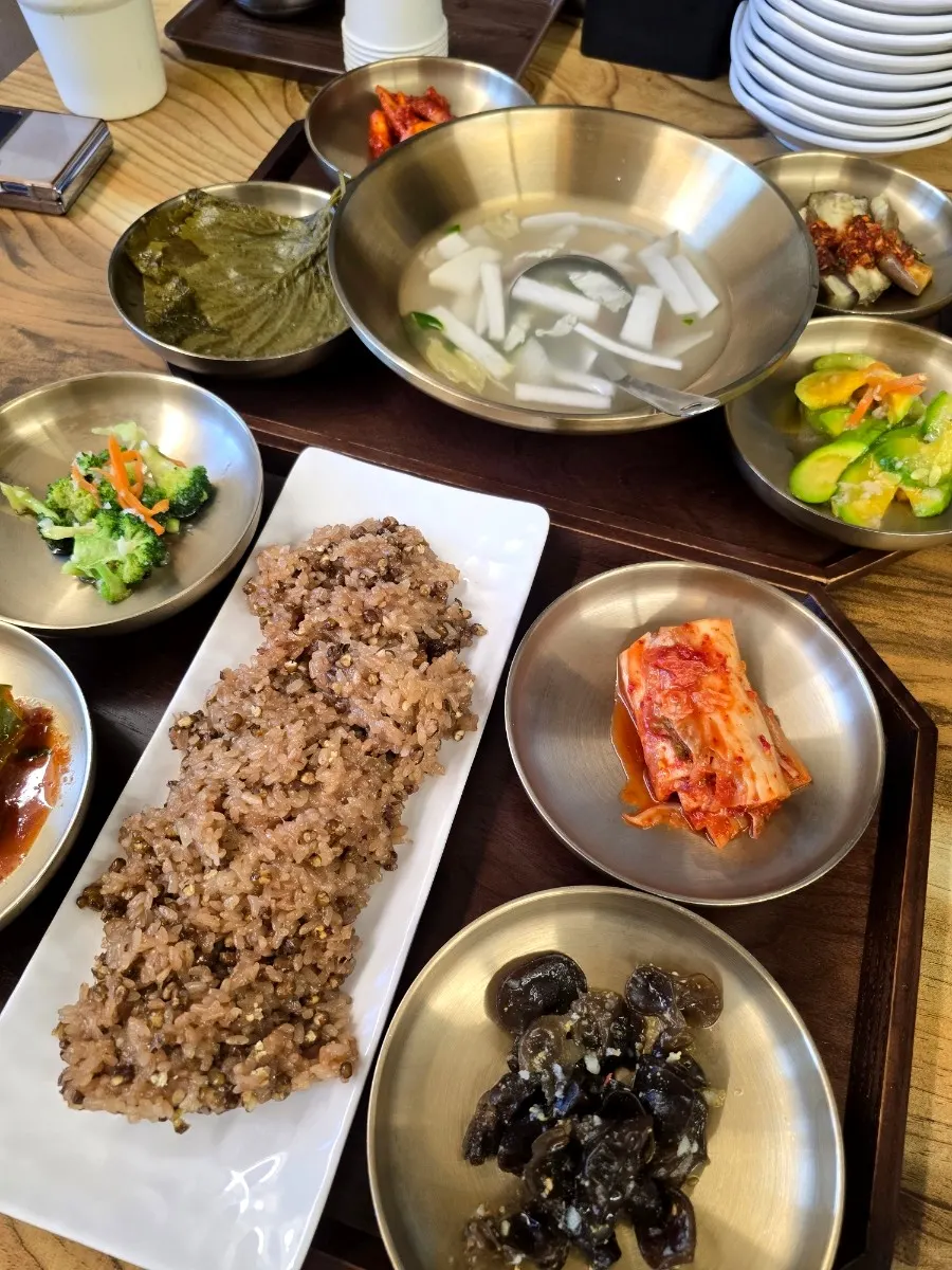 Dongchimi and napa cabbage kimchi in brass bowls