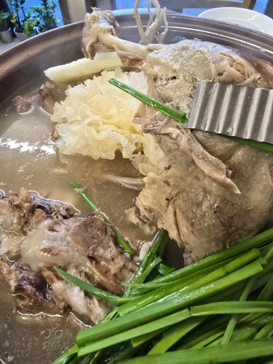 A bowl ladled with baeksuk broth