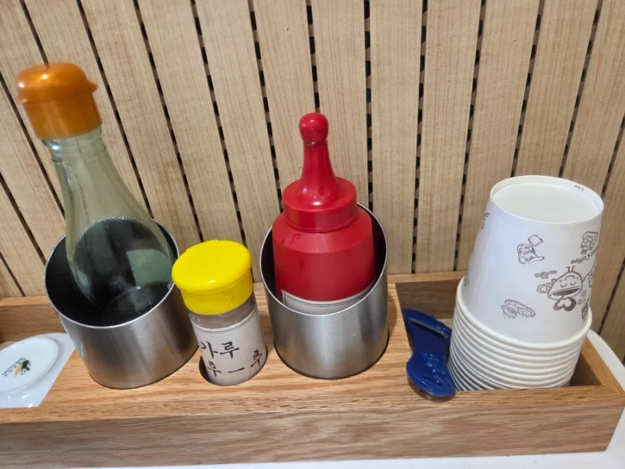 Seasonings, spices, and paper cups on the table