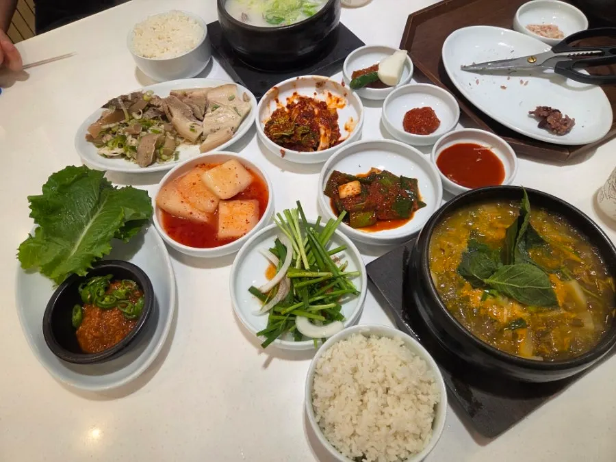 Table spread with the ordered gukbap and head meat