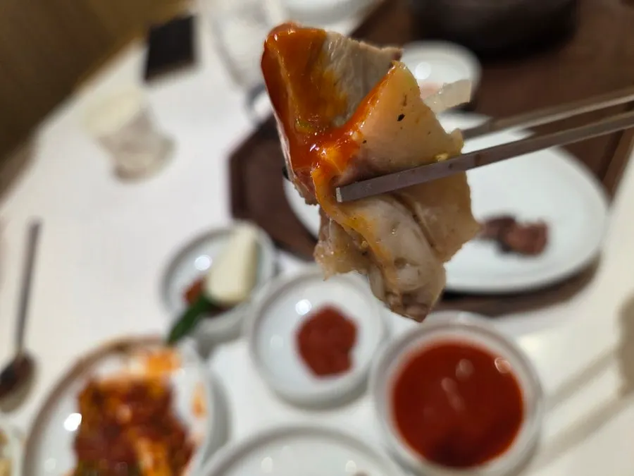 A piece of boiled pork dipped in vinegared chili sauce