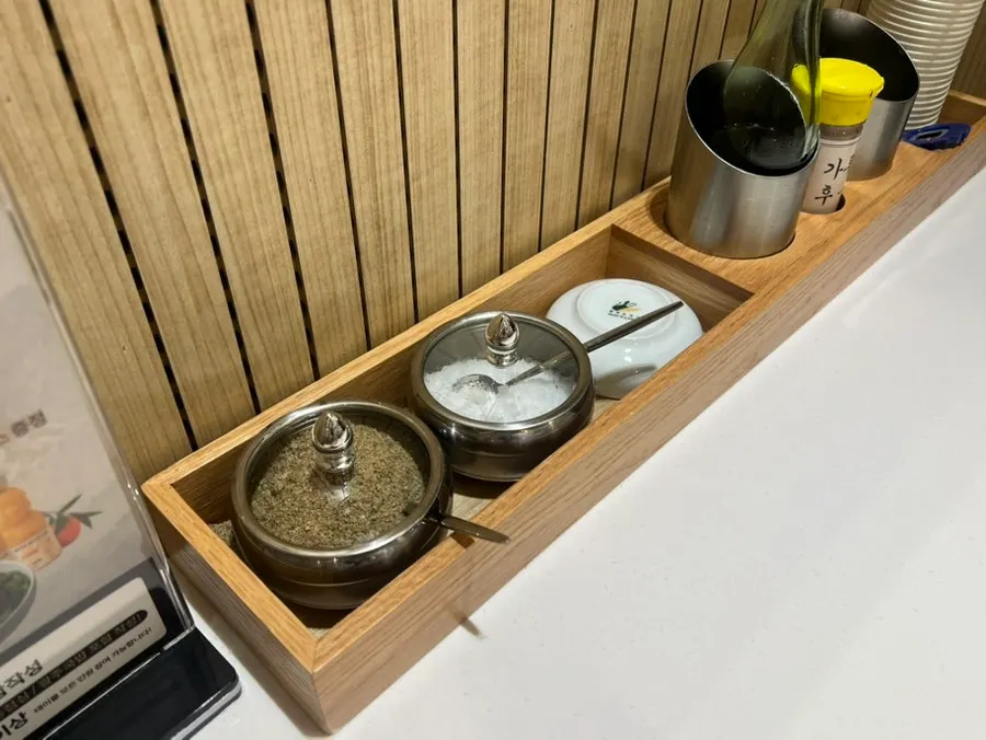 Table setting with salt, pepper, and perilla seed powder