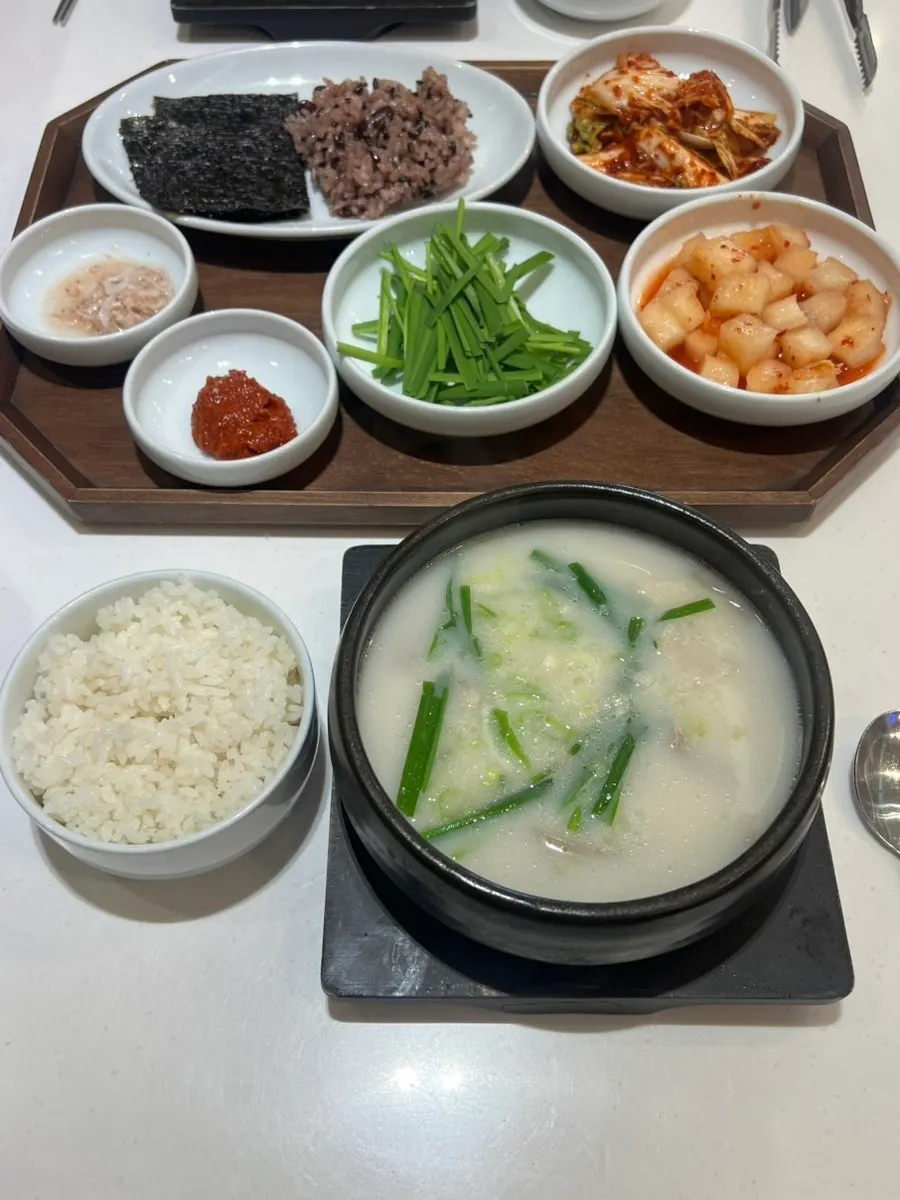 Mixed pork gukbap table loaded with extra self-serve sides