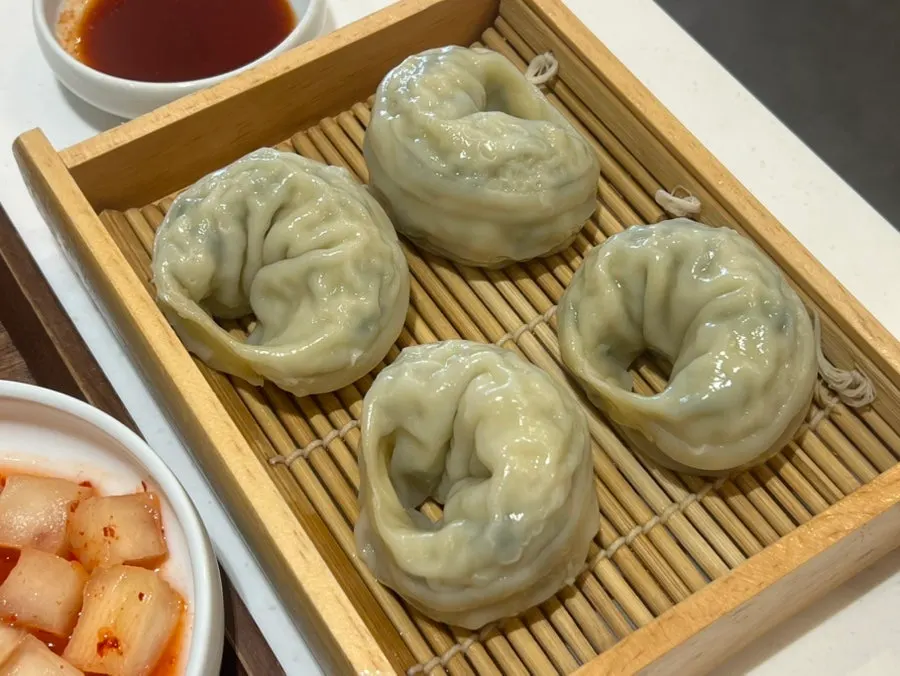 Cross-section of meat mandu dipped in soy sauce