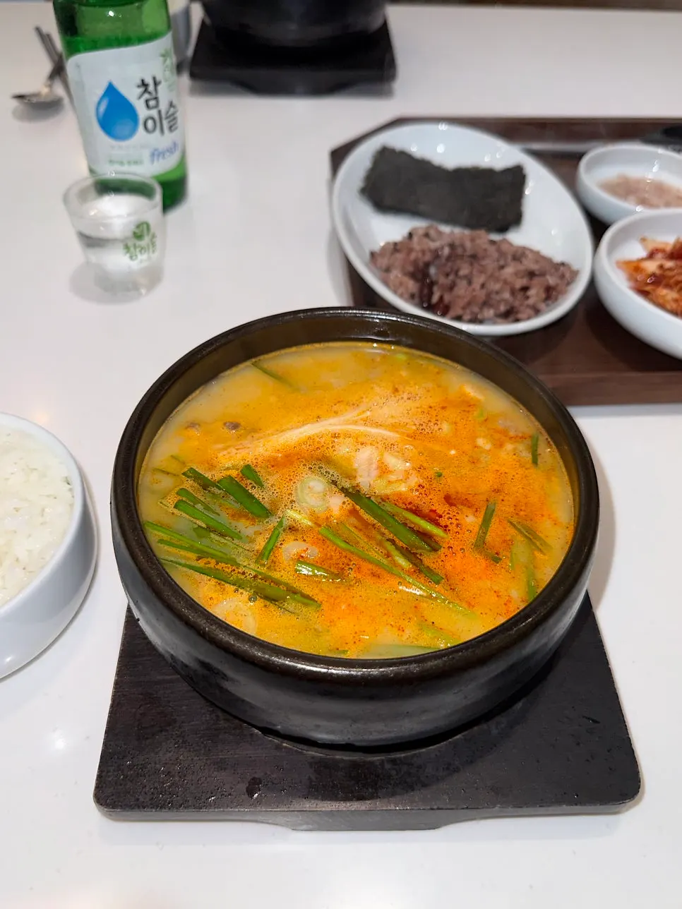 A spoonful of mixed pork gukbap loaded with meat