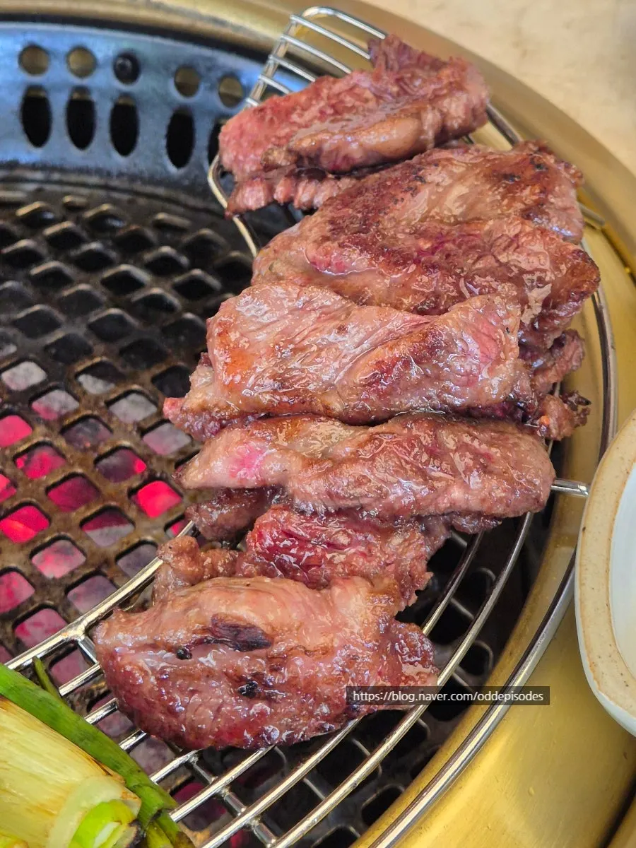 Staff grilling rib-eye on the tabletop grill