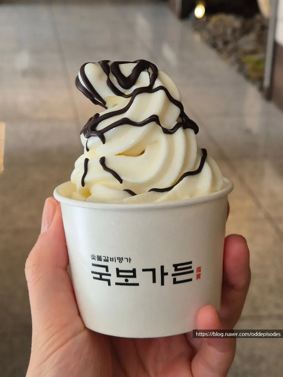 Two cups of soft-serve stacked with toppings